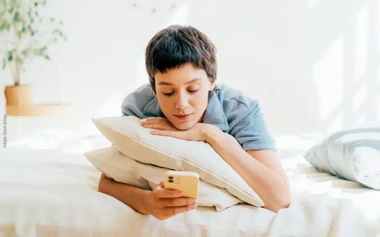 une jeune femme s'appuie sur 2 oreillers